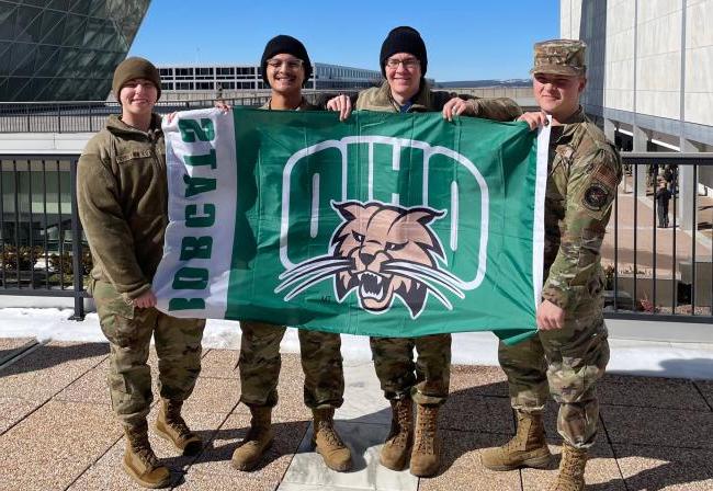 Air Force ROTC Ohio University students hold an OHIO flag in uniform
